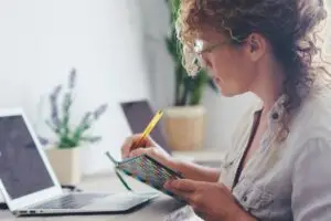 Modern housewife manage family economy at home - single lady use laptop computer